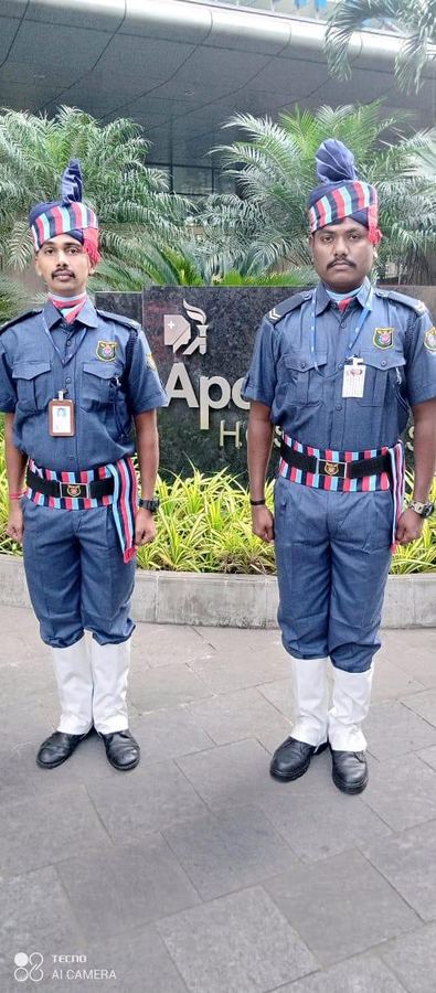 Two Industrial Security Force guards in ceremonial turban uniform at a hospital entrance