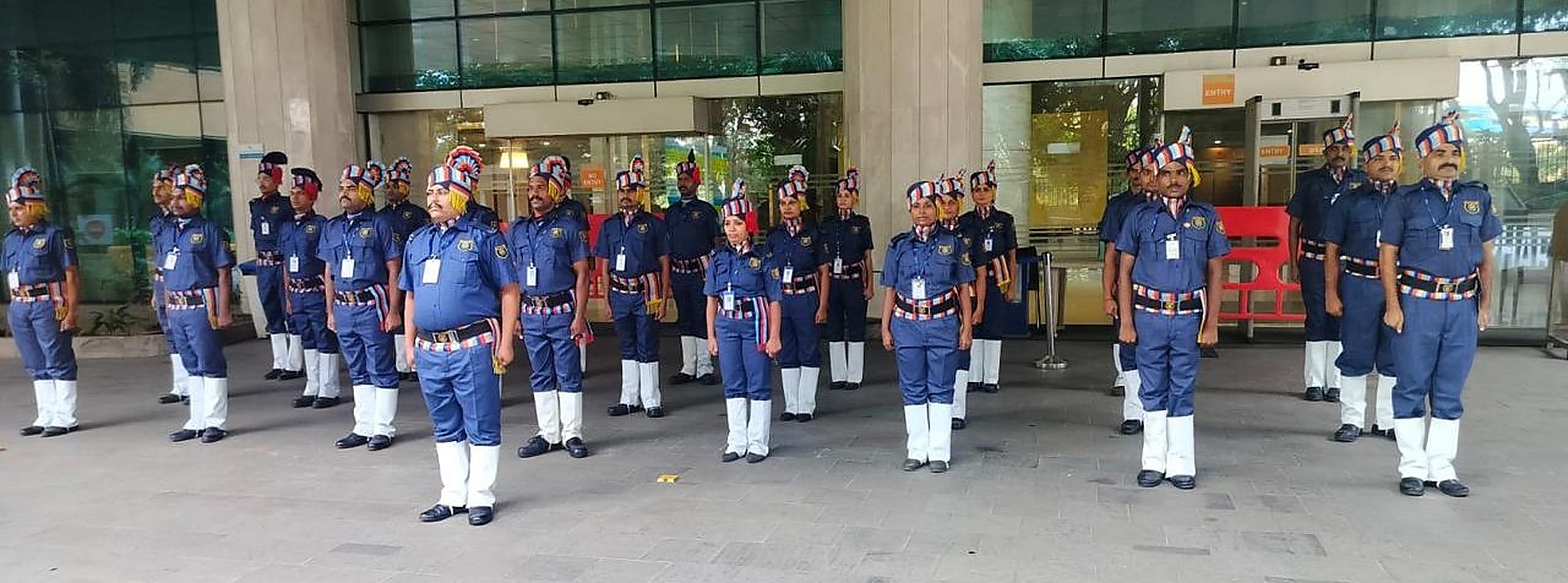 An Industrial Security Force detachment in ceremonial uniform on parade outside a hospital entrance