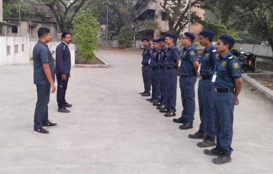 An area officer inspecting a line of Industrial Security Force guards before posting