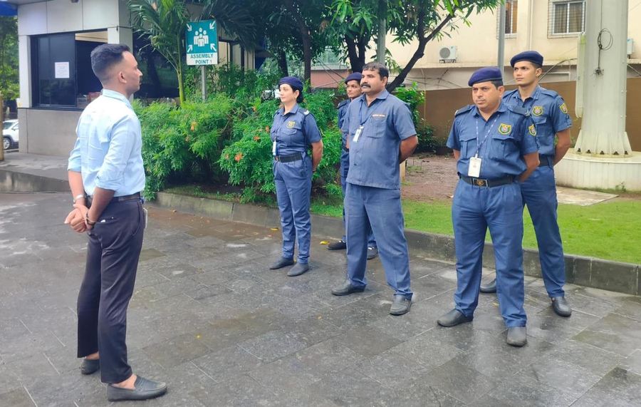 A supervisor briefing Industrial Security Force guards at the start of a shift