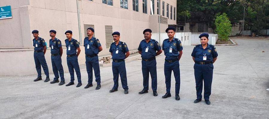Industrial Security Force guards in blue uniform lined up for inspection at a hospital site